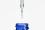 Blue glass container with a dropper dripping liquid onto a white background